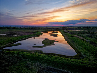 Coastal sunset scene. Aerial photograph showing tidal pools lakes and channels flowing through sand dunes. Lincolnshire Coast, Gibraltar Point.