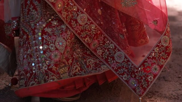 Traditional Indian Wedding Dress Of A Hindu Bride Walking Outdoor. Close-up Shot