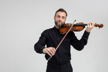 Elegant musician man violinist playing on concert