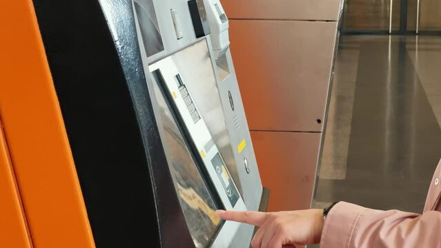 Close-up of paying by a credit card on a ticket vending machine with terminal.