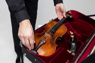 Unrecognizable violist man with instrument in case