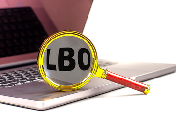 LBO word on magnifier on laptop , white background