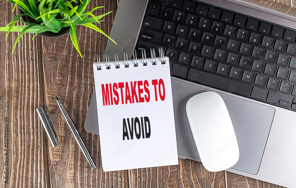Poster mistakes to avoid text on notebook with laptop, mouse and pen
