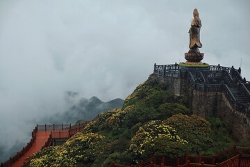 Golden statue on the top of the Fansipan mountain in Vietnam. 