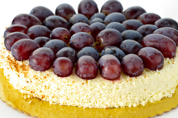 Fototapeta premium grape cake. large lush light cake with white cream and purple large grapes on top, close-up, sweet concept