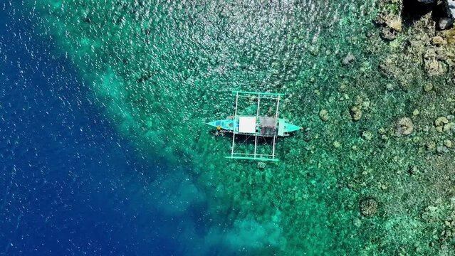 Aerial Top View of Bangka Boats as sand beach by a crystal clear water. Entalula island, Bacuit Bay, El Nido, Palawan, Philippines.	