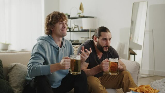 Males fan watching match on tv, drinking beer and eating chips, upset with loss result. European and World football cup, Germany 2024, USA, Canada, Mexico. Football 2026, sports and soccer fans