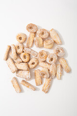 Top view of shortbread cookies in powdered sugar on light surface