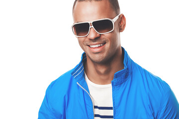 Man, happy and studio fashion with sunglasses, model and summer eyewear with confident male person. White background, stylish and trendy with face accessory, isolated and wearing eye care with smile