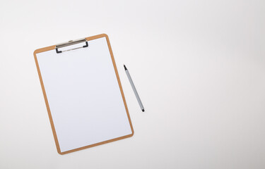 Wooden clipboard with blank white paper mock up with a pen