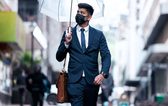 Business, man and outside with umbrella in rain, investment and financial insurance for safety or security. Assurance, accountability and protection cover for assets and face mask, future or walking