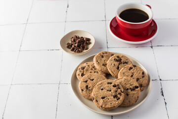 Delicious chocolate chip cookies with a red coffee cup. Breakfast. 