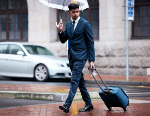 Business, man in city with umbrella or outside, luggage and travel insurance or thinking for urban...