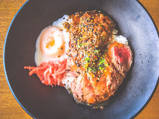 Beef Tenderloin Rice Bowl with onsen half boiled egg and pickled ginger