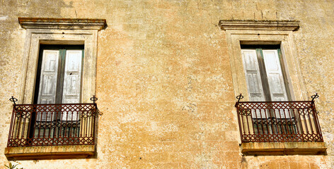 windows in the historic center of pat&ugrave; salento italy