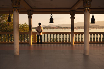 person looking over the coast of Koh Samui thailand at the big buddha temple next to architecture...
