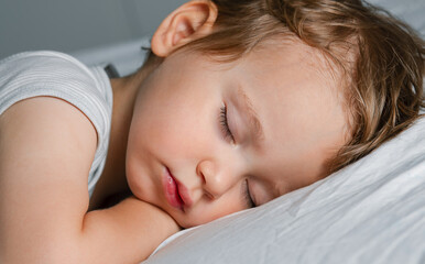 Cute small baby sleeping on the blanket, close up