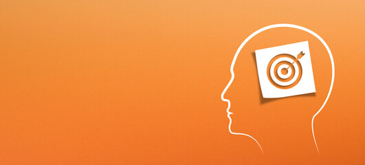 Brain of thinking about target and strategy. Target sign in note paper with human head on orange background.