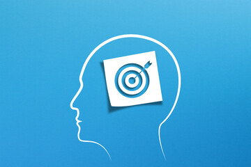 Brain of thinking about target and strategy. Target sign in note paper with human head on blue background.