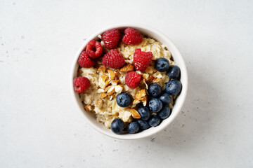 Porridge with berries, blueberry and raspberry and almond nuts