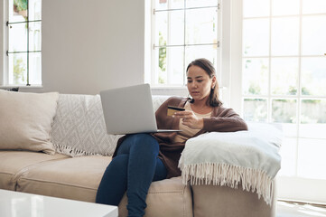 Woman, laptop and credit card on couch for buy, finance and website for online shopping in home. Female person, ecommerce and code for payment or purchase, sofa and app for banking or budget on tech