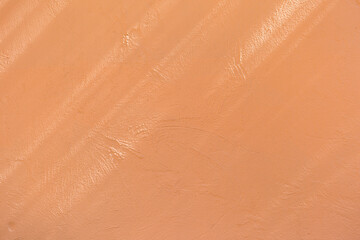 Fototapeta premium Orange cement wall under the shade background, morning light shade on blank orange wall, outdoor day light