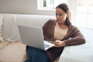 Woman, laptop and credit card on sofa for sale, finance and website for online shopping in home....