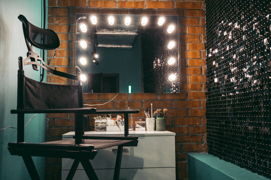 Dressing room make-up area .Dressing room for applying makeup hairstyles chair mirror lighting tools brushes, in beauty salon backstage