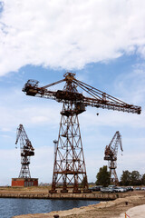 Old abandoned shipyard crane. Column crane