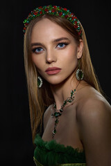 close-up portrait of a beautiful young girl with exquisite makeup on a dark background