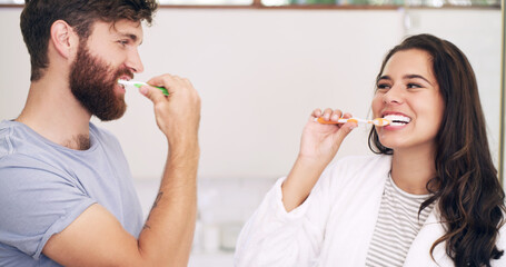 Morning, happy or couple in bathroom brushing teeth together in grooming routine with love in home....