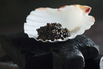Black caviar. Caviar is served in a shell. An exquisite snack. Natural omega.