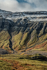 High rocky mountains covered with snow. Autumn colors in Iceland. Breathtaking landscapes,...