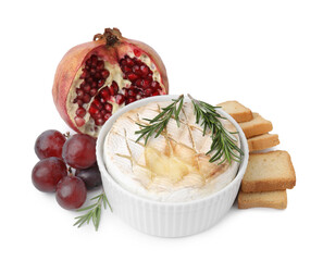 Tasty baked camembert, croutons, grapes and pomegranate isolated on white