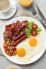 Delicious breakfast with sunny side up eggs on light table, flat lay