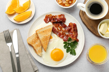 Delicious breakfast with sunny side up egg served on light table, flat lay