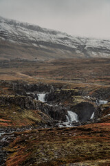 Fototapeta premium Long asphalt road runs through Iceland. Travelling, exploring, breathtaking views, volcanic landscapes.