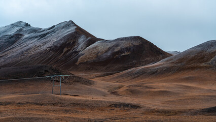 Snow-capped mountains on the horizon. Long road runs through wide valleys. Panorama, Icelandic...