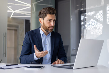 Businessman explaining in a virtual meeting from office