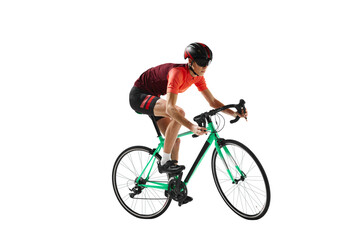 Muscular young man, athlete, cyclist in uniform and helmet, riding bicycle against transparent background. Concept of sport, action, competition, power and endurance, healthy lifestyle.