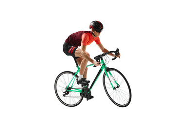 Obraz premium Muscular young man, athlete, cyclist in uniform and helmet, riding bicycle against transparent background. Concept of sport, action, competition, power and endurance, healthy lifestyle.