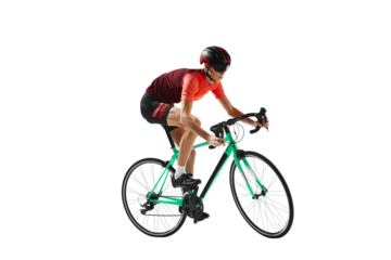 Muscular young man, athlete, cyclist in uniform and helmet, riding bicycle against transparent background. Concept of sport, action, competition, power and endurance, healthy lifestyle.