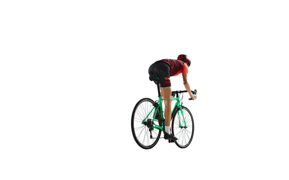 Back view. Young man, cyclist in sportswear and helmet riding bicycle, training against transparent background. Concept of sport, action, competition, power and endurance, health marathon.