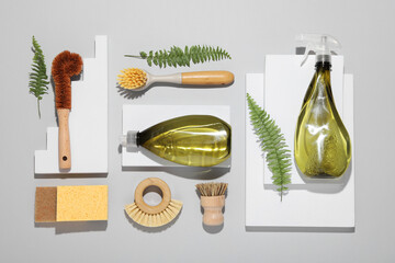 Flat lay composition with different cleaning supplies on light gray background