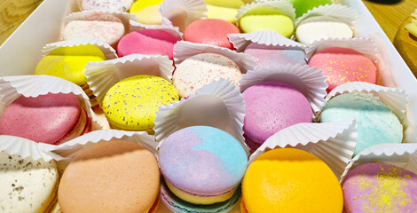 colorful macarons lie in a box