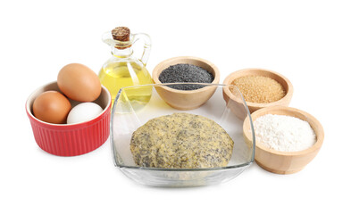 Raw dough with poppy seeds in bowl and ingredients isolated on white