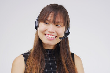 Asian woman, smile and headset in studio on white background for consultant, call centre and crm....