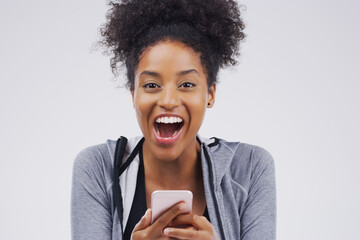 Black woman, portrait and phone surprise in studio, victory notification and lottery success. Female person, wow and excited for fitness goals on gray background, promotion email and gym discount