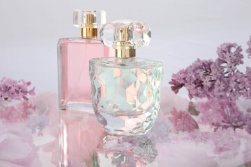 Two luxury perfumes on spring floral decor