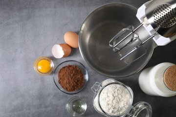 Stand mixer and different ingredients for dough on grey table, flat lay